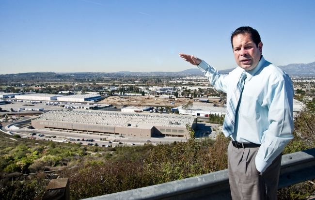 County Sanitation Districts spokesmen Sam Pedroza explains the new truck-train transfer method while over looking the waste by rail facility at the Puente Hills Landfill in North Whittier on Wednesday, Jan. 25, 2011.